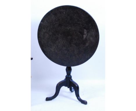 A George III pollard oak pedestal tripod table, having a circular tilt-top with original iron latch, on gun barrel turned urn