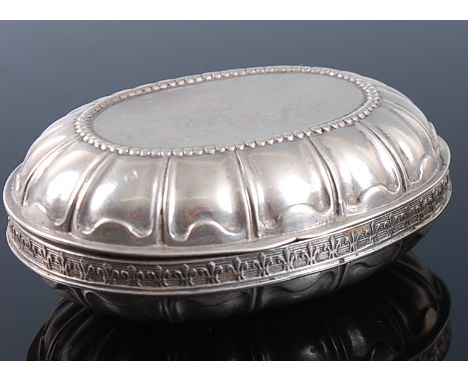 A late 19th century Hanau silver pocket snuff box, of hinged oval form, with clamshell decoration, the frieze relief decorate