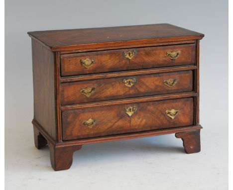 An early 20th century figured walnut and crossbanded apprentice piece miniature chest, in the early 18th century style, raise
