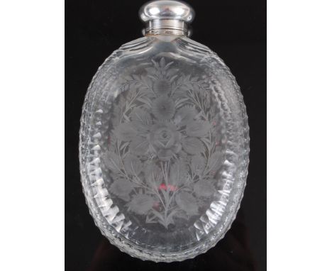 A George V cut glass and white metal mounted hip flask, the body of oval shape, acid etched with roses, with further leaves a