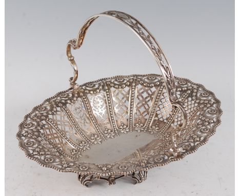 A George V silver basket, of pierced oval form within a beaded rim, having pierced swing handle, 19.4oz, maker Martin Hoare &