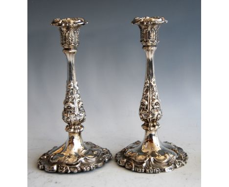 A pair of early Victorian silver candlesticks, in the mid-18th century style, each having detachable sconces, on leaf and flo