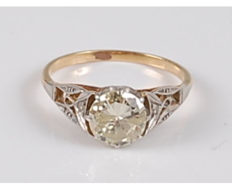 A yellow and white metal single stone diamond ring, the round brilliant cut diamond measuring approx 7.2 x 7.1 x 4.1mm, weigh