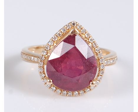 A yellow metal pear shaped ruby and diamond cluster ring, the ruby measuring approx 11.85 x 9.9 x 6.1mm, weight estimated as 