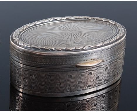 A circa 1900 continental silver pocket snuff box, of oval form, having engine turned and punch decoration, the gilt interior 