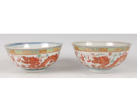 A pair of Chinese porcelain dragon bowls, each enamel decorated with Greek Key style borders, the white grounds decorated wit