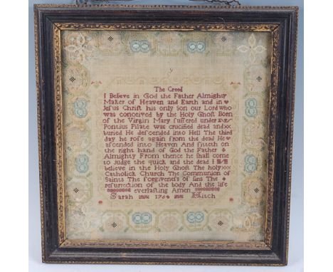 An early George III needlework sampler depicting The Apostles Creed verse, within floral border, worked by Sarah Hitch and da