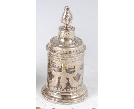 A circa 1900 continental white metal jar and cover, of cylindrical form, the cover with flaming torch finial to a three prong