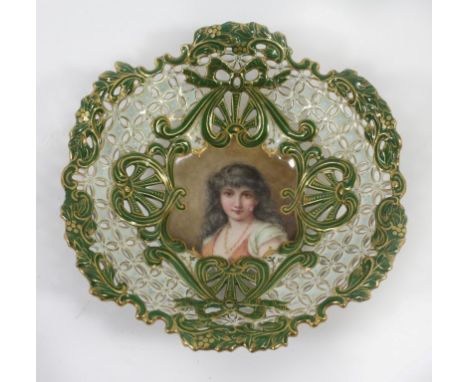 A Coalport lattice bowl 
Of circular form, decorated with central portrait panel of a young lady surrounded by ribbon and gar
