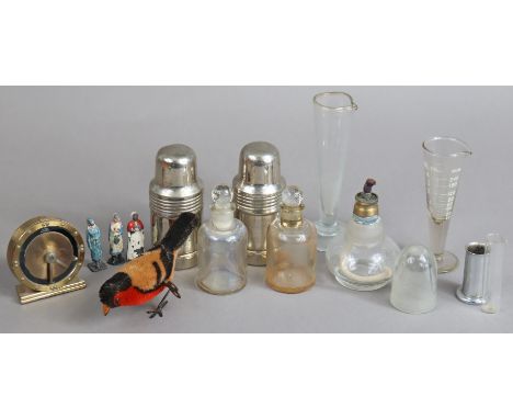 A Cyma Watch Co. (Swiss) brass travelling alarm clock; a cloth-covered clockwork-operated bird toy; three painted lead nurse 