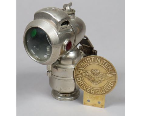 A Powell &amp; Howell of Birmingham chrome bicycle lamp, 18cm high; &amp; a brass “Austin Ten Driver’s Club” car badge.