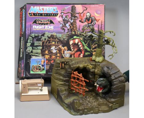 A 1980’s Mattel Masters of The Universe Fright Zone model (1985) boxed; &amp; a child’s Singer sewing machine, unboxed.