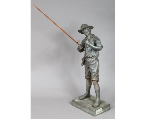 A bronzed sculpture in the form of a standing fisherman with fishing rod in his right hand &amp; with fish in his left hand, 