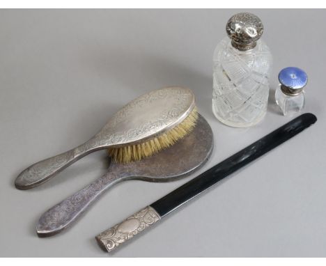 An Edwardian engraved silver-backed hairbrush Birmingham 1909; a ditto George V hand mirror Birmingham 1912; a vintage ebony 