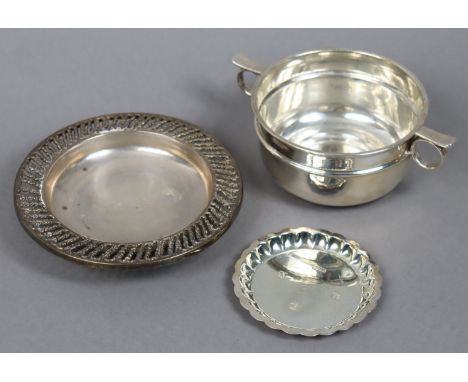 An Edwardian silver circular two-handled bowl, 10.75cm diameter, London 1908; together with two silver dishes, 14cm &amp; 8.7
