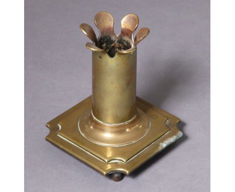 A Victorian brass candle holder with petallated rim &amp; plain column on a shaped square base with ball feet, 13cm wide 16cm