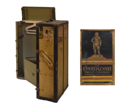 Vintage 'Oshkosh' steamer trunk opening to reveal four drawers and hanging compartment, the canvas exterior with many shippin