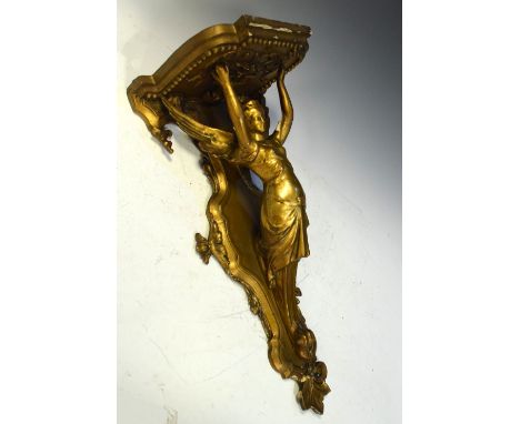 19th/20th Century carved gilt gesso wall bracket formed as an angel with arms aloft supporting a shelf, 62cm high  