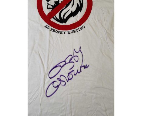 An original t-shirt (XL) designed by Ozzy Osbourne, signed in black marker pen by Ozzy Osbourne. Provenance: donated by Ozzy 