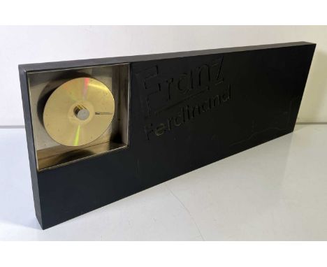 A French presentation gold disc for Franz Ferdinand designed by Hedi Slimane from Christian Dior. Measures at approx 29.5" x 