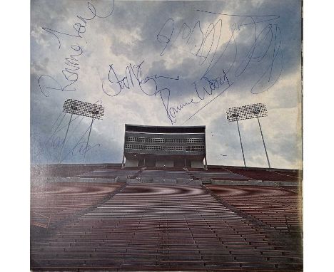 A portion of the record sleeve for Rod Stewart - Never a Dull Moment, signed in blue ink by Ronnie Lane, Rod Stewart, Ronnie 