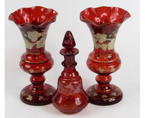 A pair of Bohemian ruby glass vases, over decorated in enamel and gilt with irises, late 19thC, 17.5cm high, and a glass scen