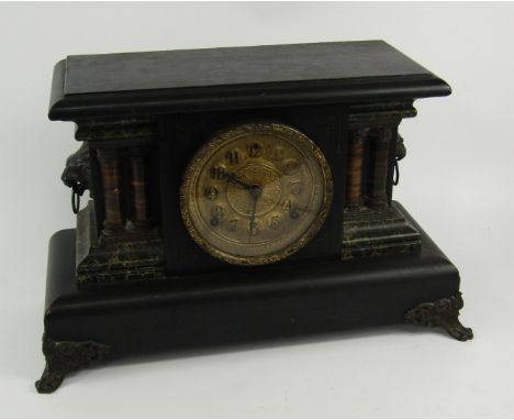 An American faux slate and marble mantel clock, late 19thC, of architectural form, brass dial bearing Arabic numerals, eight 