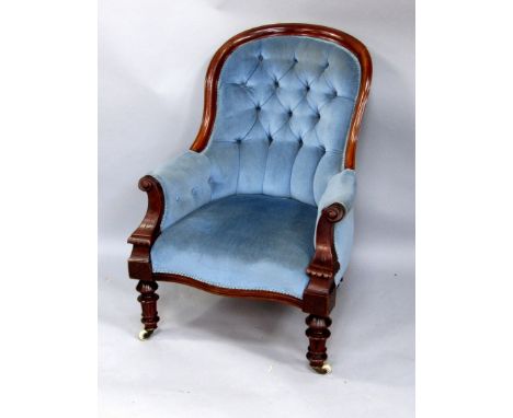 A Victorian mahogany showframe armchair, with a button back, arm rests and seat, upholstered in blue dralon fabric, on turned