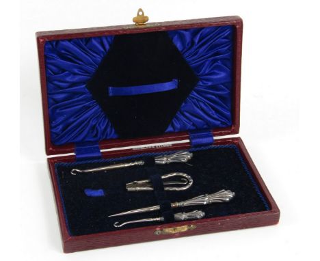 A George V silver and steel four piece button hook set, Birmingham 1912, cased