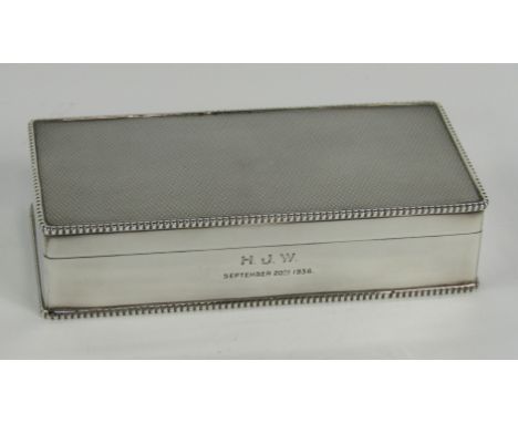 A George V silver twin division cigarette box, with engine turned decoration, presentation engraved, Birmingham 1929, 19cm x 