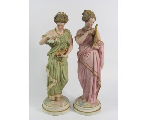 A pair of Robinson and Leadbetter Parian figures of Roman ladies, modelled standing and playing a lyre, the other with an oil