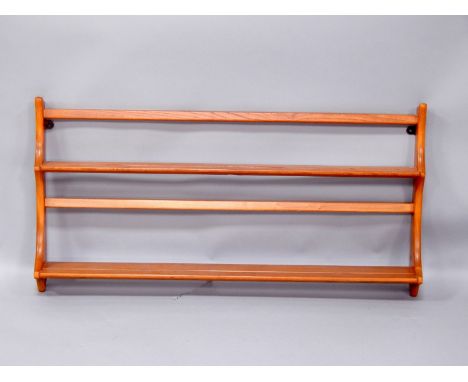 An Ercol retro style light elm wall shelf or plate rack, 97cm wide