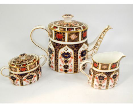 A Royal Crown Derby porcelain coffee pot, decorated in the Old Imari pattern, together with a cream jug and sucrier, pattern 