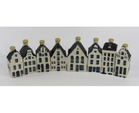 A set of eight delftware Bols liqueur bottles, modelled as houses for KLM, numbers 13, 21, 30, 22, 10, 74, 49 and 70.