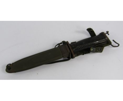 A US bayonet, with a black plastic grip, metal scabbard stamped M8AI, 31cm long.