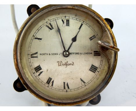 A North & Sons Watford car clock, black enamel casing with pull lever to set hands