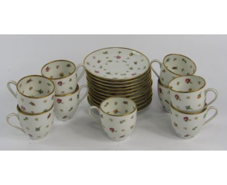 A Legrand & Cie porcelain part coffee service, Limoges, decorated with flowers, comprising nine cups and eleven saucers.