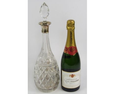 A bottle of Charles de Villers brut champagne, and a cut glass decanter and stopper, with silver collar, London 1933, (2).