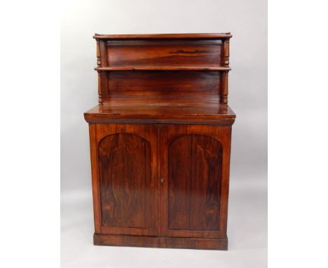 A Victorian rosewood chiffonier, the galleried two shelf back above a pair of panelled doors enclosing two shelves, raised on