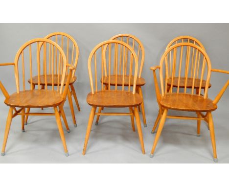 A set of six Ercol ash and elm stick back dining chairs, circa 1960, comprising a pair of carvers and four single chairs.