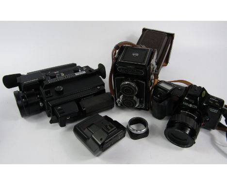 An Elmo Super 8XL sound camera, 3000AF macro with auto focus, cased, Minolta Dynax 7000i camera and auto card.