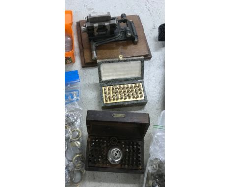 Quantity of watchmakers parts and tools to include wristwatch cases, pocket watch glasses, Boley staking set, Seitz Bouchons,