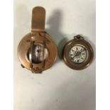 Two brass cased compasses of military style