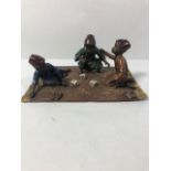 Cold painted bronze of a group of Arabic children playing a Dice game sat on a carpet