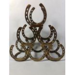 Brass horse shoe wine bottle rack approximately 39 x 40 x13 cm