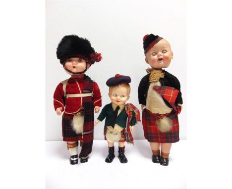 THREE HARD PLASTIC DOLLS comprising a Pedigree Scotsman, with a clockwork walking mechanism (currently inoperative), wearing 