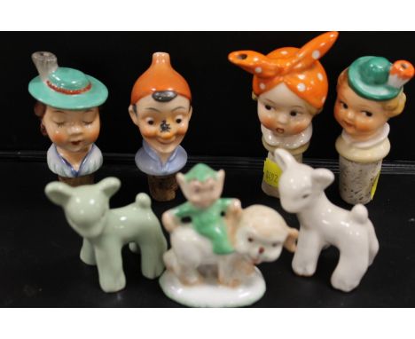 A SELECTION OF GOEBEL PORCELAIN HEADED BOTTLE STOPPERS TOGETHER WITH THREE MABEL LUCIE ATTWELL STYLE FIGURES (7)