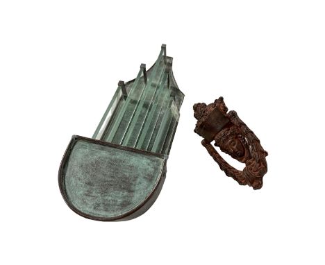 A cast metal door knocker together with a metal and glass exterior light.