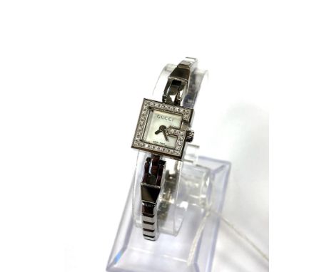 A lady's Gucci diamond watch, set with 33 diamonds and mother of pearl dial