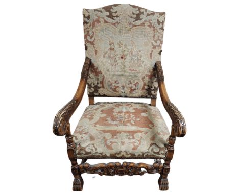 A late 19th century Continental heavily carved oak armchair with tapestry upholstered seat. (width 67cm)
